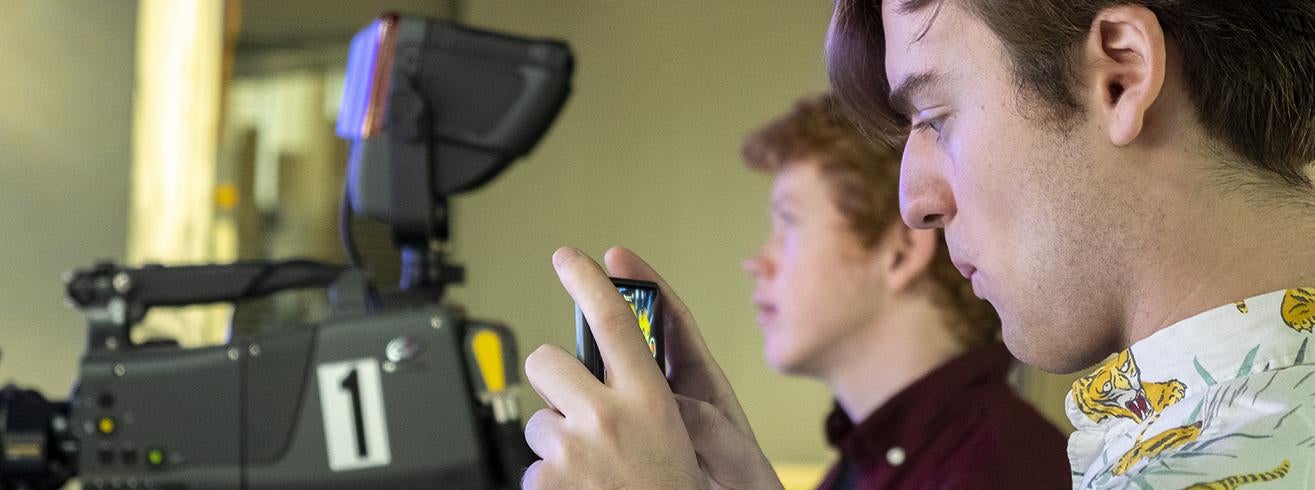 students films with phone during broadcast class