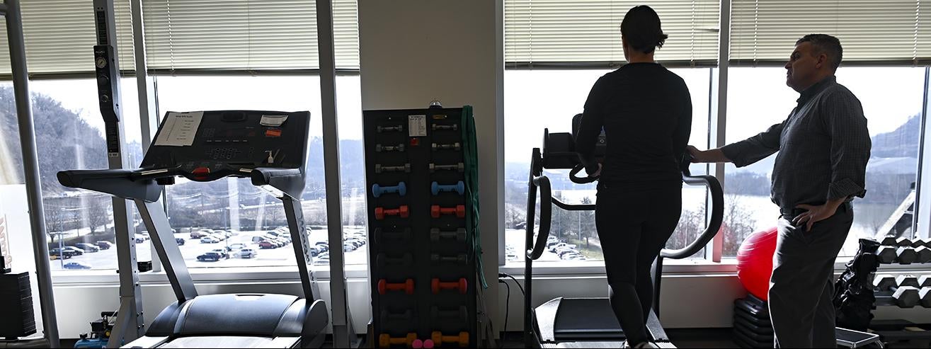 person walking on treadmill with supervision