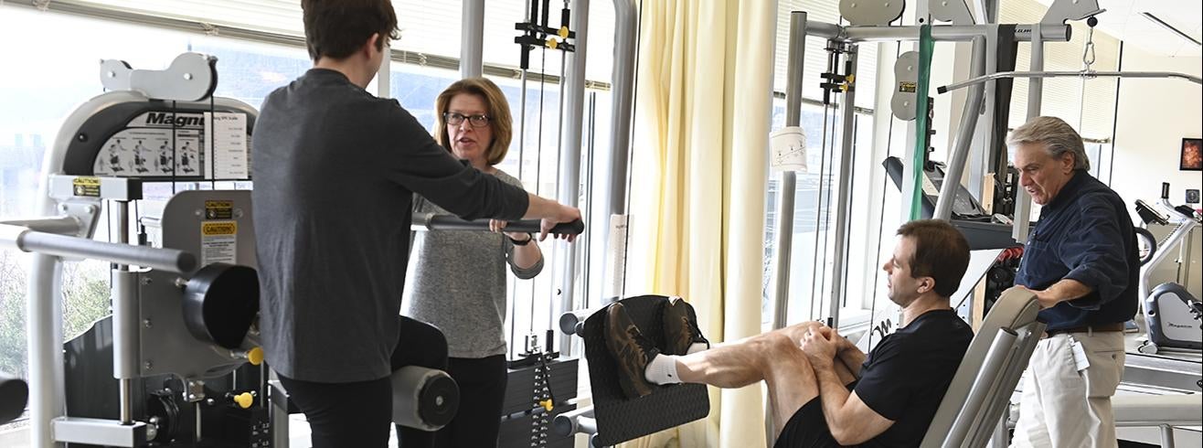 students and faculty with physical therapy exercise equipment