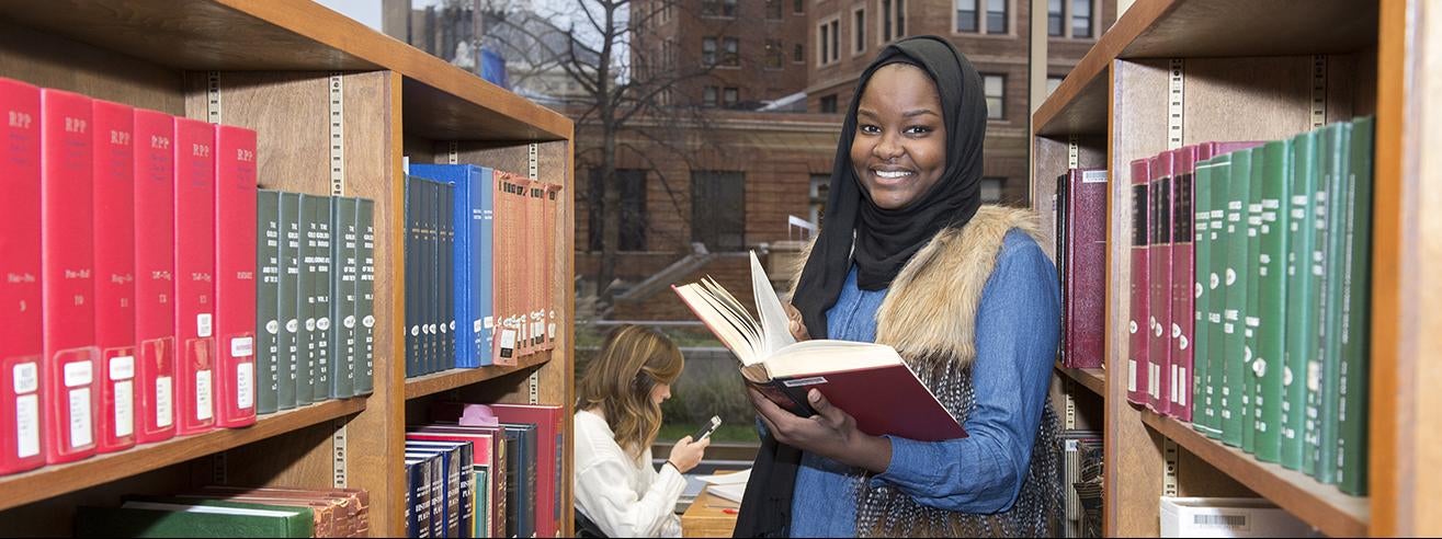 student in library