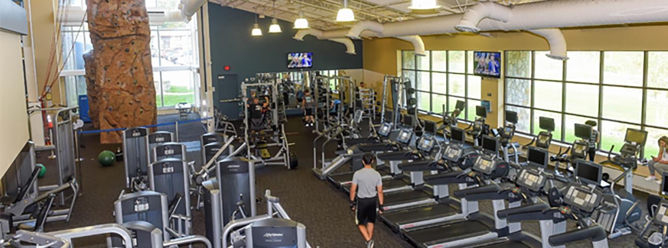 overhead view of treadmills and weight machines in a light-filled gym