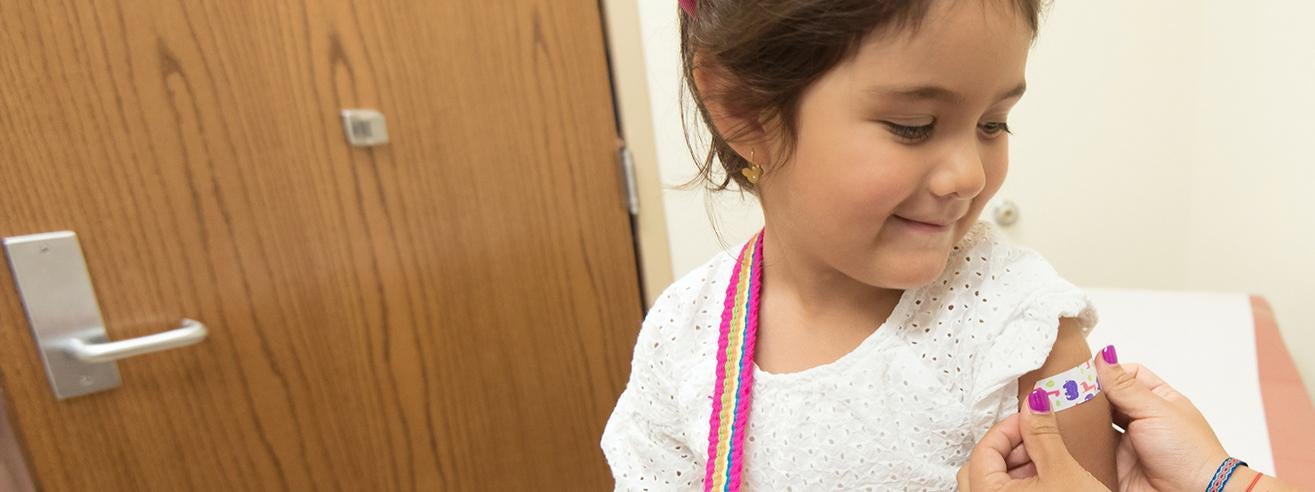 child receiving bandage after vaccine