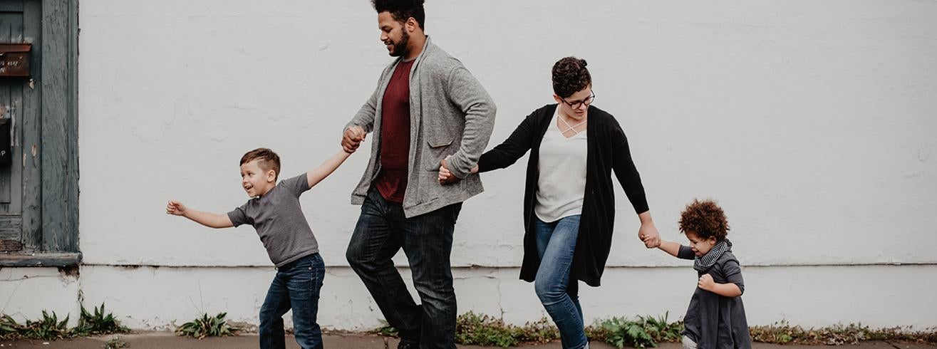 parents walking with two children