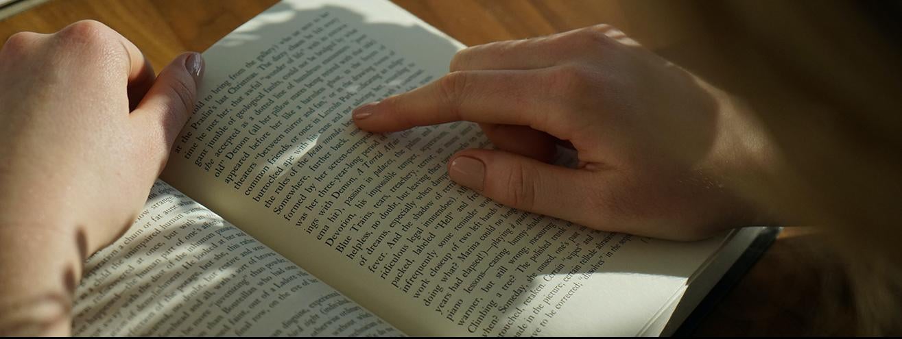 closeup of person's hands holding a book open