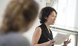 woman speaking in front of class