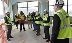 people in hardhats and reflective vests at construction site