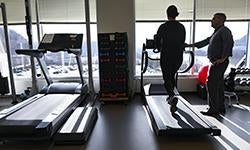 person walking on treadmill with supervision
