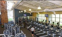 overhead view of treadmills and weight machines in a light-filled gym