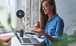 person communicating with sign language via laptop